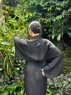 This black robe is a stunning Halloween black kimono gown, perfect for adding a touch of dark elegance to your wardrobe. Its loose and flowing design makes it an ideal gothic bathrobe for women, combining comfort with a dramatic flair. The robe features subtle, intricate patterns, reminiscent of a jacquard dress, adding texture and depth to its design. Inspired by traditional Japanese attire, it carries an animalistic Japanese robe aesthetic, blending unique cultural elements with a bold, contem Black Long Party Robe, Black Kimono With Kimono Sleeves For Party, Black Long Kimono For Party, Long Black Evening Robe, Black Long Evening Robe, Black Long Sleeve Kimono For Party, Long Black Party Kimono, Gothic Kimono, Dark Kimono Aesthetic