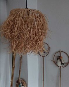 there are some decorative items hanging on the wall in this room and one is made out of straw