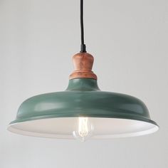 a green and white light hanging from a ceiling fixture with a black cord attached to it