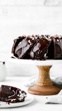 a chocolate cake on a plate with one slice cut out