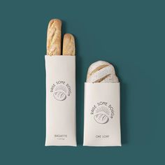 two baguettes sitting next to each other on a blue background