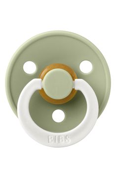 a green pacifier with an orange and white ring on the top of it's head