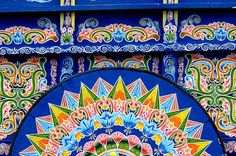 an intricately decorated wall with blue and yellow colors