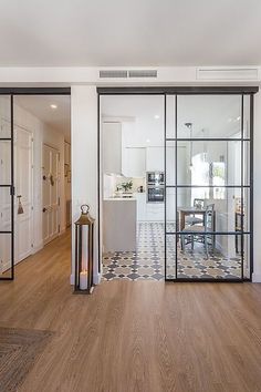 an open living room and dining area with sliding glass doors that lead into the kitchen