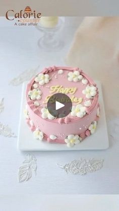 a pink cake with white flowers on it