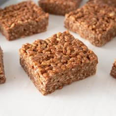 several squares of food sitting on top of a white surface