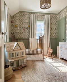 a baby's room with a crib, rocking chair and toy house on the rug