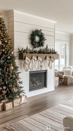 a living room with a christmas tree and fireplace