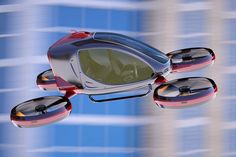 a red and black toy flying in the air next to a tall building with lots of windows