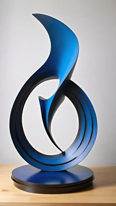 a blue sculpture sitting on top of a wooden table