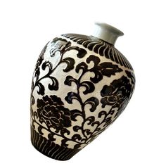 a black and white vase is shown against a white background