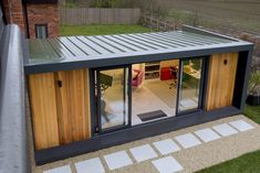 an outdoor room with sliding glass doors on the outside and wood panels on the inside