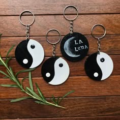 three yin key chains with the word i am in black and white painted on them