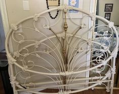 a white metal bed frame in a room