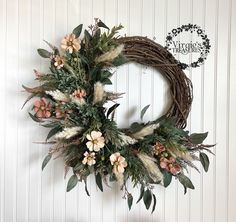 a wreath hanging on the wall with flowers