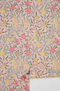 a pink wallpaper with fruit and leaves on it