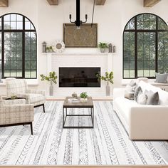 a living room filled with white furniture and lots of window panes above the fireplace