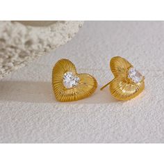 These elegant Heart Stud Earrings are a stunning addition to any jewelry collection. Made with high-quality materials, each earring features a delicate heart-shaped design that adds a touch of romance to any outfit. Perfect for any occasion, these earrings are sure to make a statement and capture hearts. Gold Heart-shaped Earrings For Her, Gold Heart Earrings With Heart Detail, Tiny Heart-shaped Gold Earrings, Hypoallergenic Gold Heart-shaped Earrings, Valentine's Day Heart-shaped 14k Gold Huggie Earrings, Love And Co, Heart Studs, Heart Earrings Studs, Trendy Jewelry