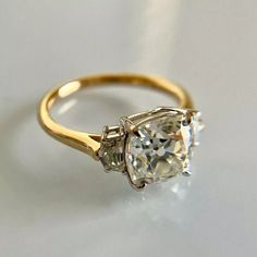 a yellow gold ring with an oval cut diamond