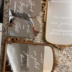 three mirrors with writing on them are sitting on the counter next to each other,