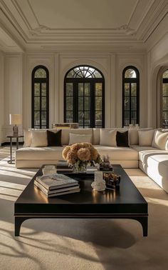 a living room filled with furniture and lots of windows