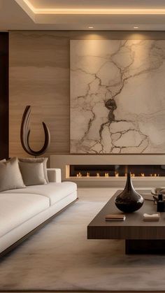 a modern living room with white couches and marble wall