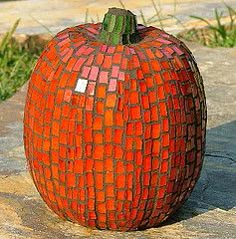 an orange pumpkin sitting on top of a stone slab