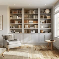 a living room filled with furniture and bookshelves next to a window on top of a hard wood floor