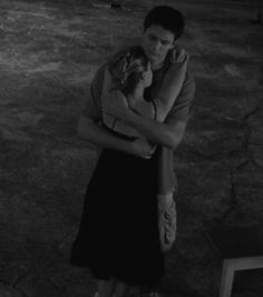 black and white photograph of two people hugging each other