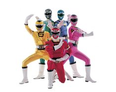 five people dressed in different colored outfits and helmets, all standing side by side with their arms up