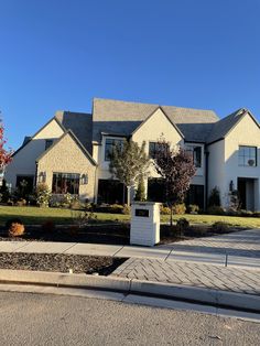 a large white house sitting on the side of a road