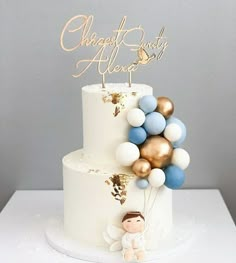 a white cake with blue and gold balloons on top