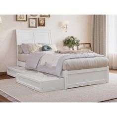 a white bed sitting on top of a wooden floor