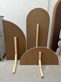 three pieces of cardboard sitting on top of a table next to each other in a room