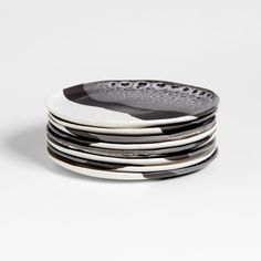 black and white plates stacked on top of each other