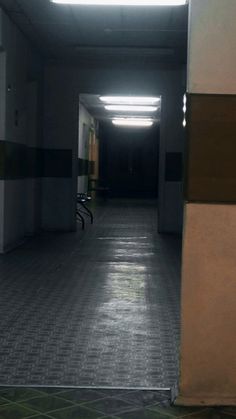 an empty hallway with no one in it at night or on the other side,