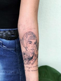 a woman with a tattoo on her arm