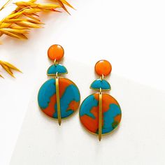 These colourful statement earrings are made from hand casted eco friendly resin coloured with orange and turquoise opaque pigment.  All of the components are brass apart from the ear posts and backs which are nickel free, hypoallergenic stainless steel, so they're perfect for sensitive skin.  Measuring approximately 3cm width x 6cm length, you don't need to worry about them being heavy...as resin is lightweight they're super comfortable.  ❤️ Your jewellery will arrive on a presentation card and wrapped in tissue. If your sending as a gift and want me to include a note from you, on plain card, just leave a message at checkout. If you'd prefer your message on a cute birthday card they're available for £2, here's the link - https://www.etsy.com/uk/listing/1128179895/birthday-card-available-wh Turquoise Resin, Colourful Jewellery, Presentation Cards, Turquoise Drop Earrings, Cute Birthday Cards, Earrings Resin, Bold Earrings, Orange And Turquoise, Colorful Jewelry