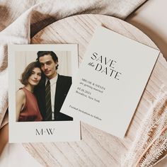 a wedding save the date card with an image of a couple on it next to a piece of wood