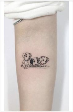 a woman's leg with two dogs on it, one is black and the other is white