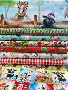 a stack of colorful fabrics with farm animals on them