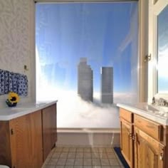 a bathroom with a large window overlooking the city