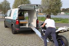 a man on a motorcycle with the back door open