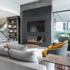 a living room with couches, chairs and a fire place in the fireplace area