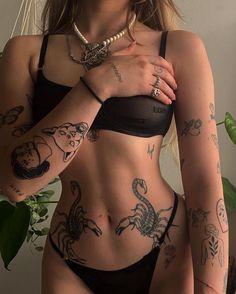 a woman with tattoos on her stomach and chest