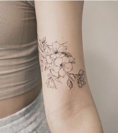 a woman's arm with a flower tattoo on the left side of her body