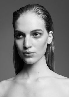 a woman with very long hair and no shirt on is posing for a black and white photo