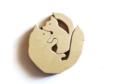 a wooden ornament with a cat and dog in the shape of a circle