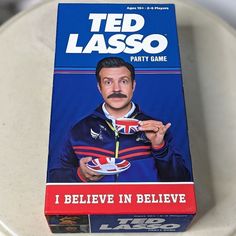 a card game called ted lasso i believe in believe on top of a toilet