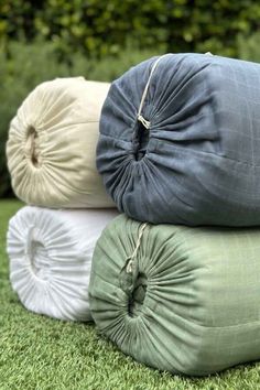 four pillows stacked on top of each other in the grass